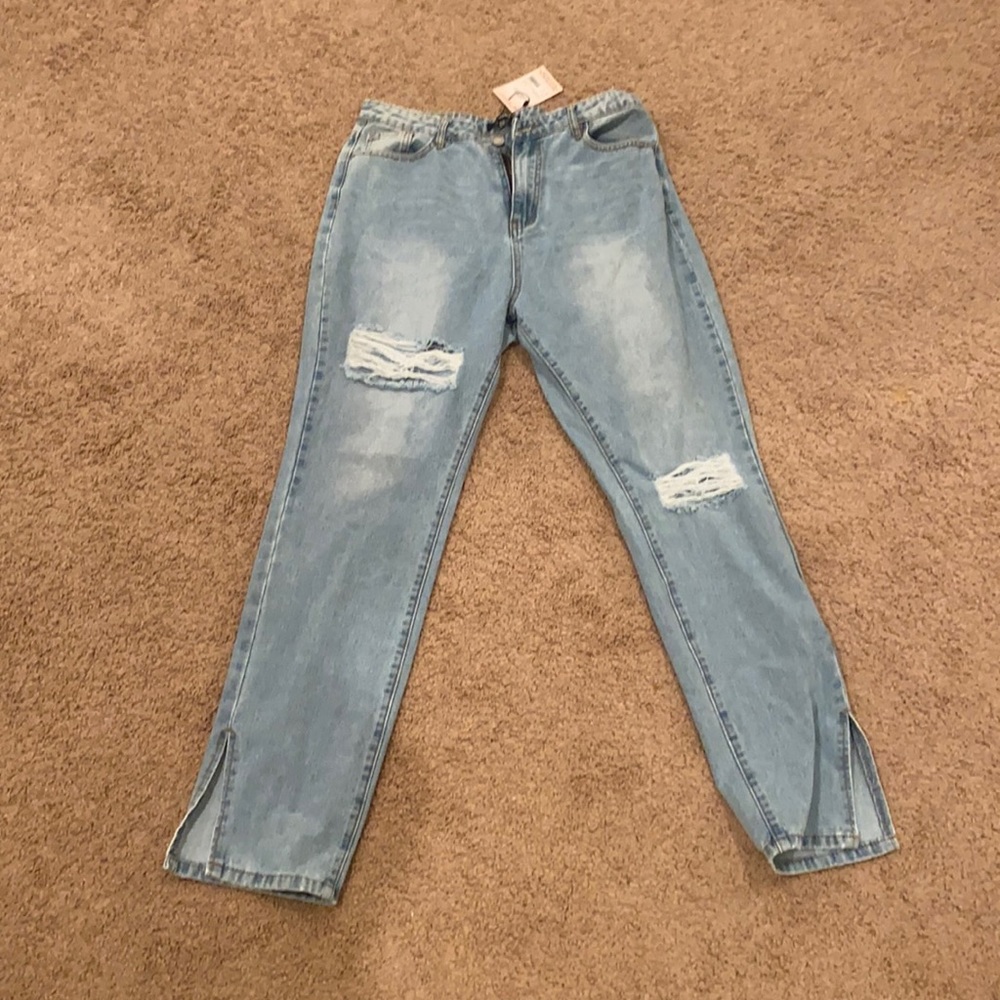 Ripped jeans with slit at the bottom.